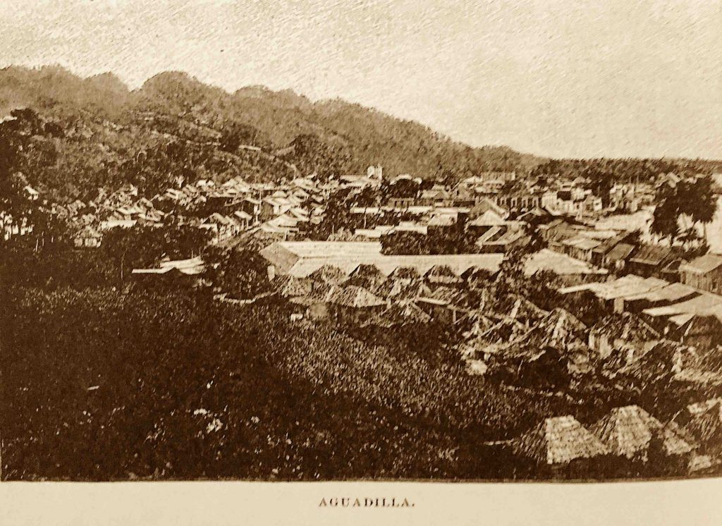 foto shows landscape with houses and bay of Aguadilla in 1898